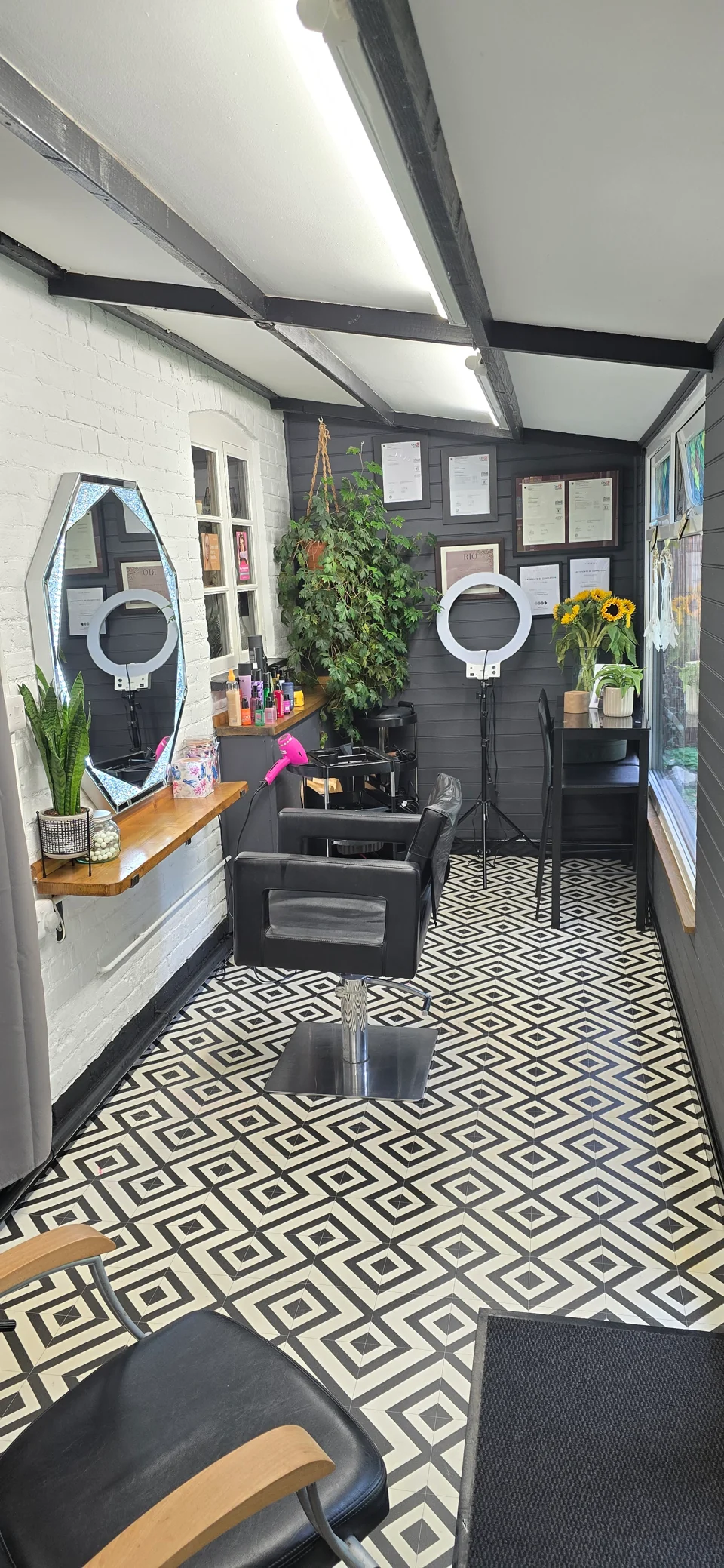 Styling chair and mirrors above the distinctive black-and-white floor at Phoenix 47 Hairdressing