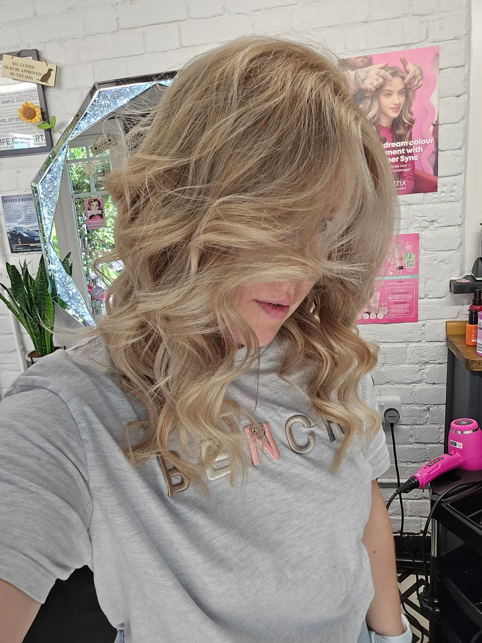 Long blonde layers and loose curls framing the face